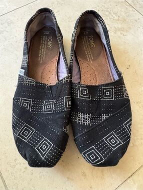 Toms Black Canvas Slip-On Shoes with White Geometric Pattern